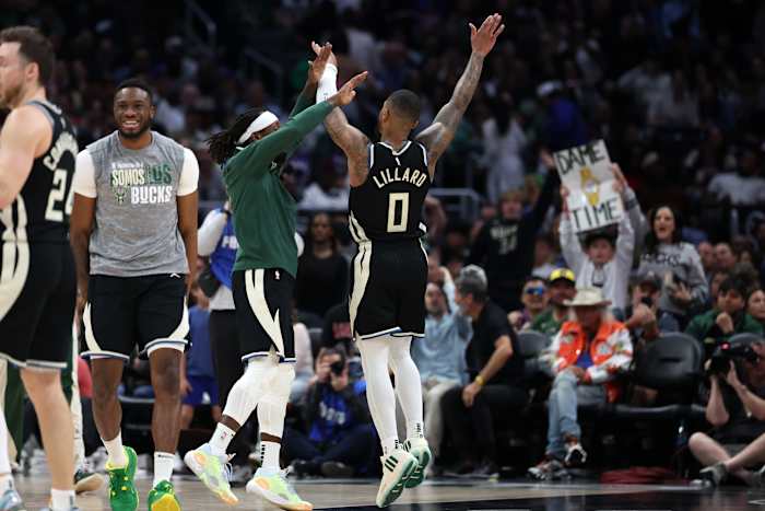 Milwaukee Bucks guard Damian Lillard (0) celebrates with teammates after making a three point basket
